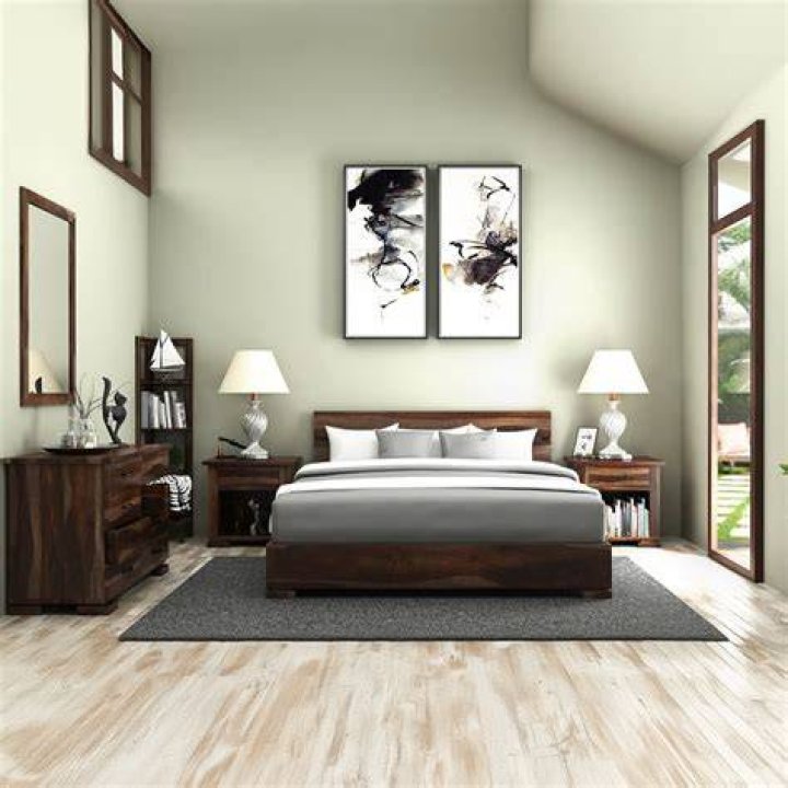 a bedroom with a bed covered in a colorful comforter and matching