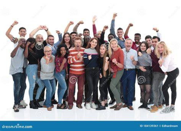 a group of people standing next to each other in front of a building