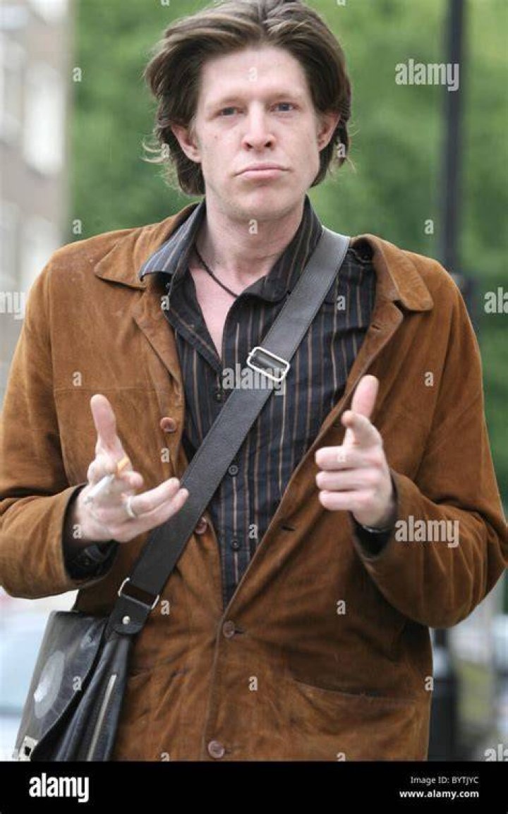 Chris Brosnan takes a cigarette from a photographer, then asks him for