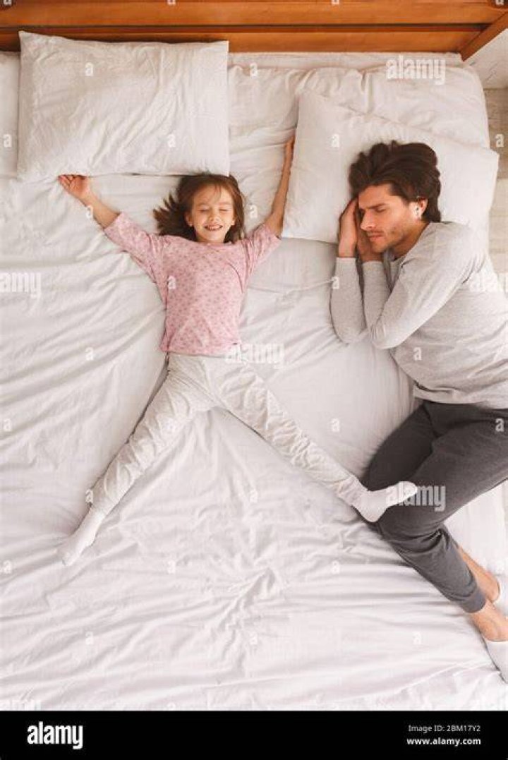 Father and daughter sleeping on couch Stock Photo Dissolve